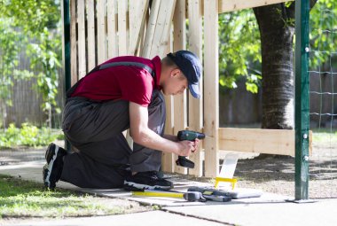 Young man holding drill-drive 