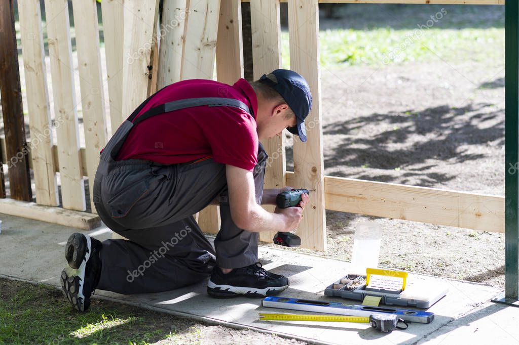 Young man holding drill-drive 