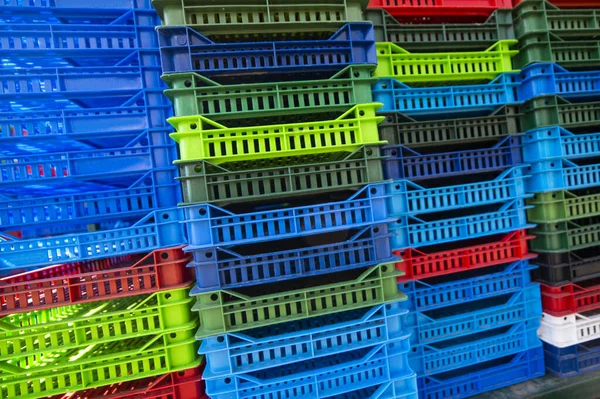 Colorful plastic boxes stacked one upon the other Royalty Free Stock Photos