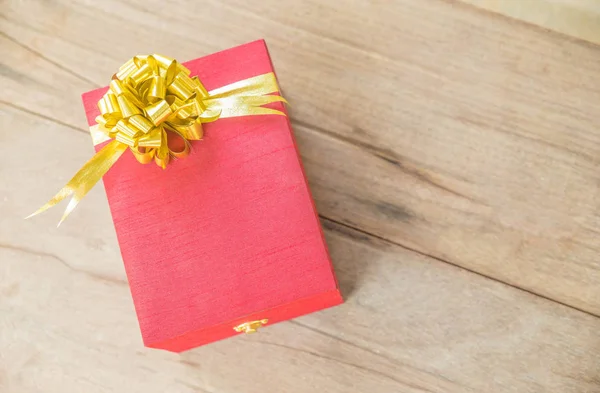 Red gift box on wooden background — Stock Photo, Image