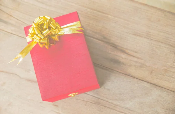 Red gift box on wooden background — Stock Photo, Image