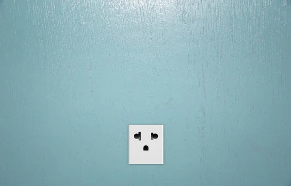 Double plug socket on the wall on wood  background