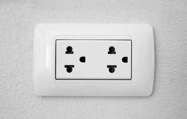 Double plug socket on the wall on white background