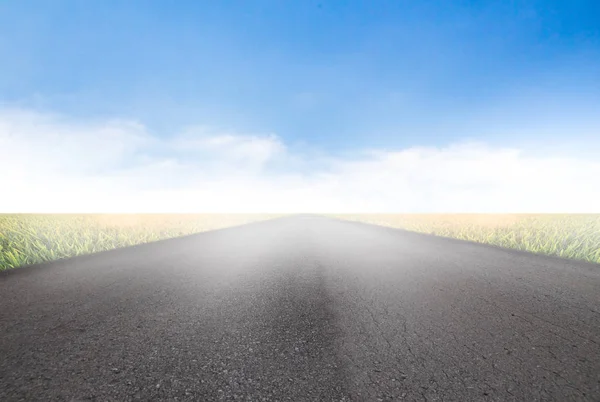 Camino de asfalto en perfecto campo verde en el cielo — Foto de Stock
