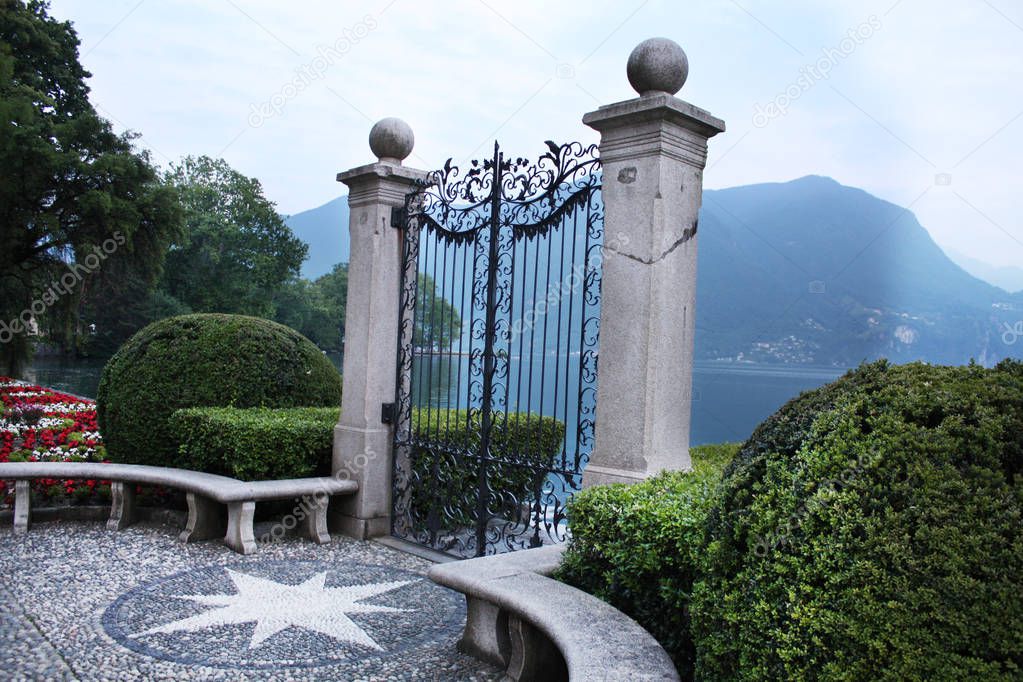 View of the old gates of Parco Ciani in Lugano city on a spring day, Canton Ticino, Switzerland.