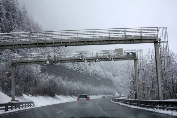 highway road in Alps with snow