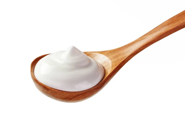 Cream sour in wooden spoon — Stock Photo, Image