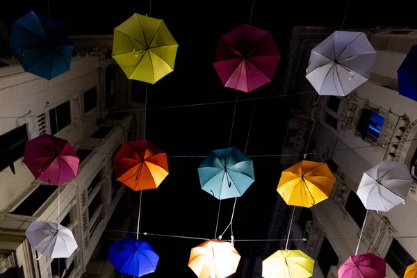 Umbrellas hanging from town streets in Genoa at night for euroflora expo — Stock Photo, Image