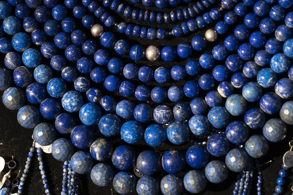 Lapislazuli necklage earrings jewelry on display stand in a shop market