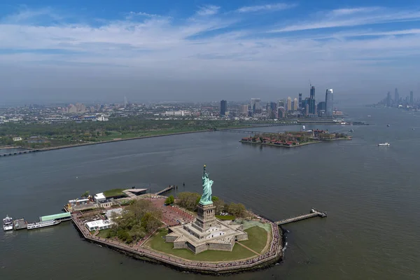 statue of liberty and new york city manhattan downtown aerial view from helicopter