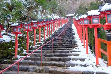 The lantern-lined steps in winter snow at Kibune clipart