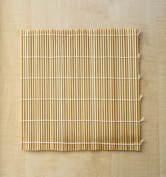 Wood background with bamboo mat. Bamboo brown straw serving mat. Free space for your design and home interior