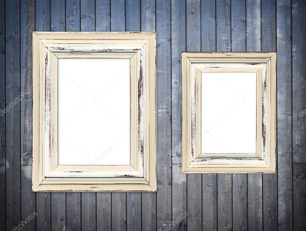 Two old wooden frames on a dark wooden wall