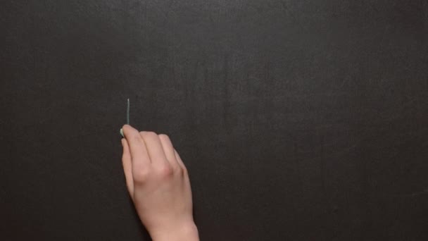 Hello. A left female hand writes the word by green chalk on a black board. — Stock Video