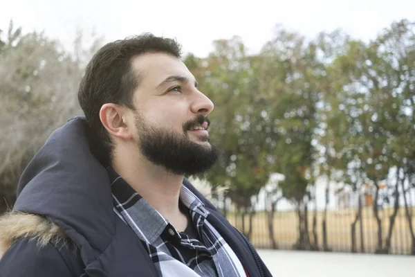 Bearded man profile in autumn image with warm clothing in outdoo