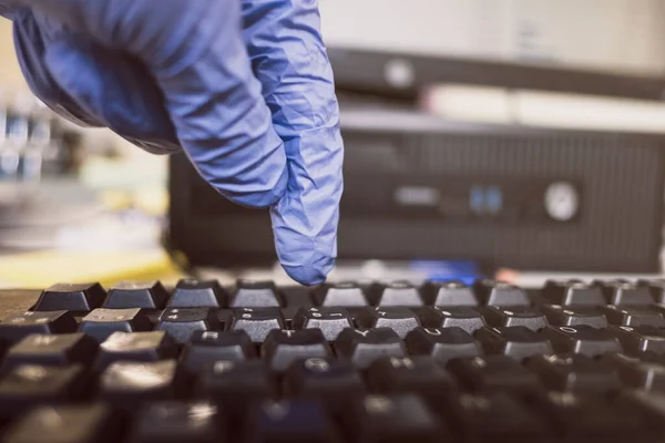 Man with gloves writing in keyboard, close up images