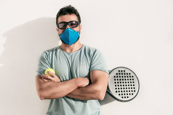 Paddle tennis player on white background with facial mask