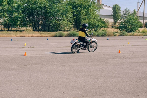 Platform for learning to drive a motorcycle. Lessons in motorcycle school.  Bike driving courses for adults. Man learn to drive a bike. Improve driving skills on the training ground
