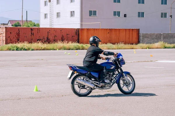 Platform for learning to drive a motorcycle. Lessons in motorcycle school.  Bike driving courses for adults. Man learn to drive a bike. Improve driving skills on the training ground