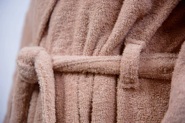 Details of a man\'s robe. Male Bathrobe close-up. Bathrobe beige color on the man