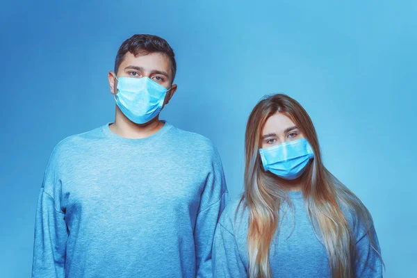 Man and woman in a medical mask. Family portrait during a pandemic. Protective medical face mask. Covid 19 Pandemic Virus Protection.