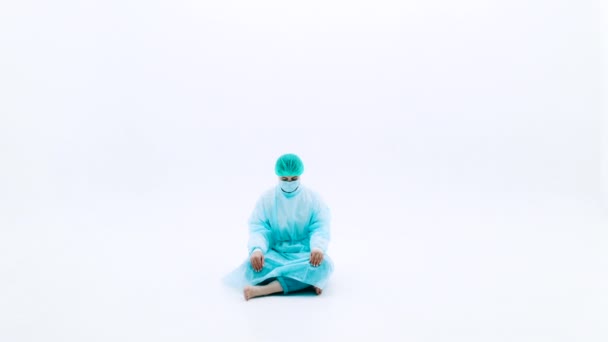 Woman Protective Medical Suits Face Masks Man Sitting White Background — Stock Video