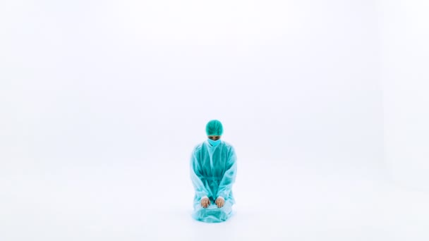 Woman Protective Medical Suits Face Masks Man Kneeling White Background — Stock Video