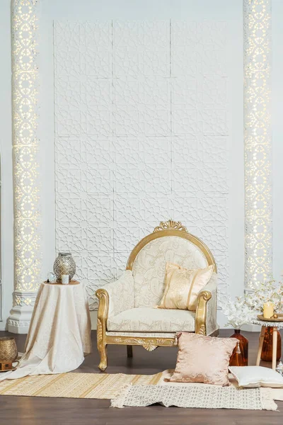 White and gold interior chair and tables in Oriental style. Moroccan middle East Decoration in Eastern Arabic style design. White room in Oriental style