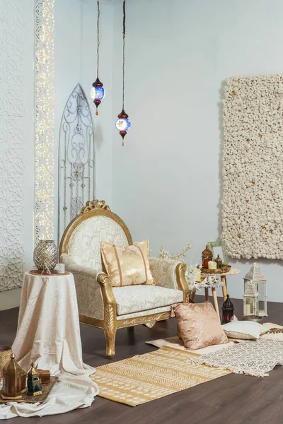 White and gold interior chair and tables in Oriental style. Moroccan middle East Decoration in Eastern Arabic style design. White room in Oriental style