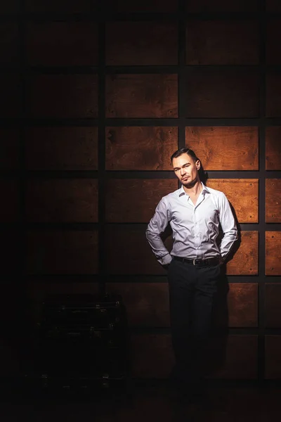 Portrait of a man in a white shirt and suit on a dark background. Beautiful stylish man business portrait. Young Asian businessman