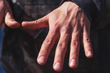 Adamın eklemli parmakları. Bir işçinin erkek eli, yakın plan. Ellerinde nasır izleri var.