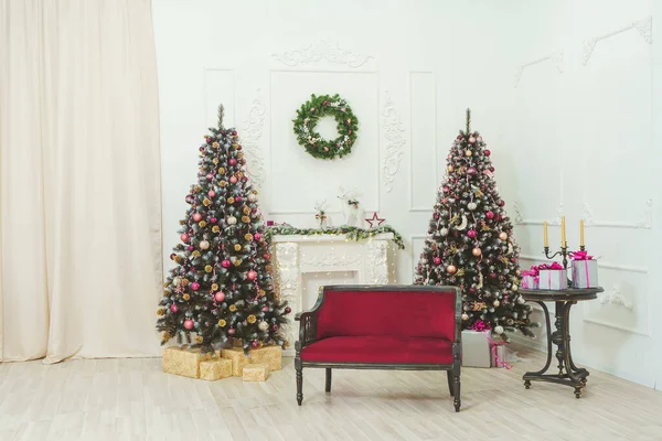 Red Maroon Sofa Fireplace Christmas Trees Balls Ribbons Garlands Rose Royalty Free Stock Photos