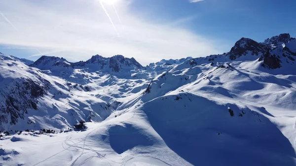 Luchtfoto van de Alpen in Frankrijk. Bergtoppen bedekt met sneeuw. Alpine ski faciliteiten van bovenaf. — Stockfoto