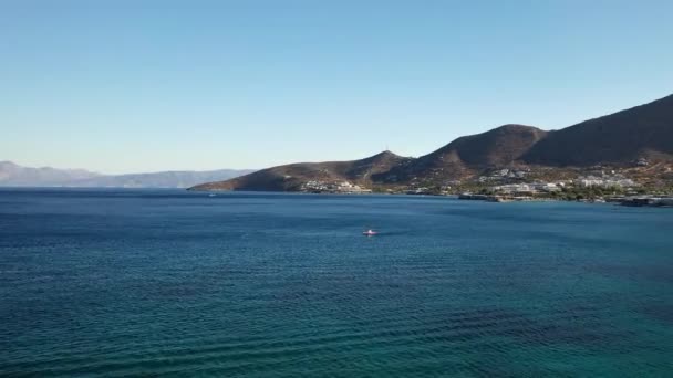 Vue aérienne d'un bateau à moteur en excès de vitesse dans une mer de couleur bleu profond. Île de Spinalonga, Crète, Grèce 