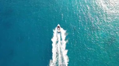 Bir su kayakçısını çeken motorlu teknenin hava görüntüsü. Elounda, Girit, Yunanistan
