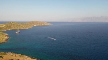Bir su kayakçısını çeken motorlu teknenin hava görüntüsü. Elounda, Girit, Yunanistan