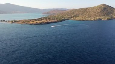 Bir su kayakçısını çeken motorlu teknenin hava görüntüsü. Elounda, Girit, Yunanistan