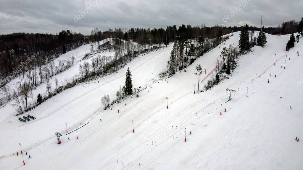 Aerial view of downhill skiing at local ski resort. Ski lift. Russia, Leningrdaskaya oblast, village Korobitsyno near Saint Petersburg.