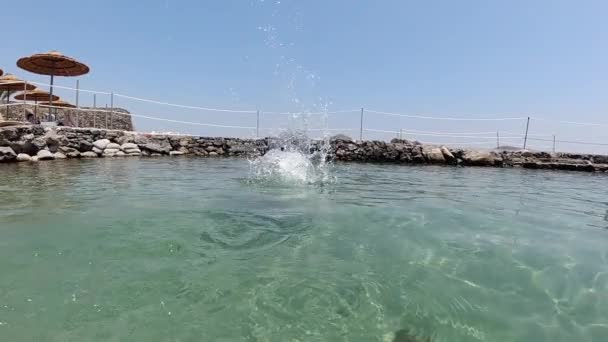 Throwing stone into Mediterranean Sea in slow motion, Crete, Greece. — Stock Video