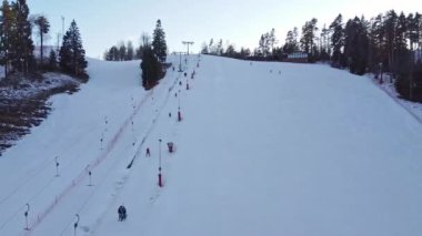 Aerial view of downhill skiing at local ski resort. Ski lift. Russia, Leningrdaskaya oblast, village Korobitsyno near Saint Petersburg.