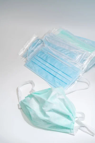 Surgical mask with rubber ear straps. Typical 3-ply surgical mask to cover the mouth and nose. Procedure mask from bacteria. Protection concept.