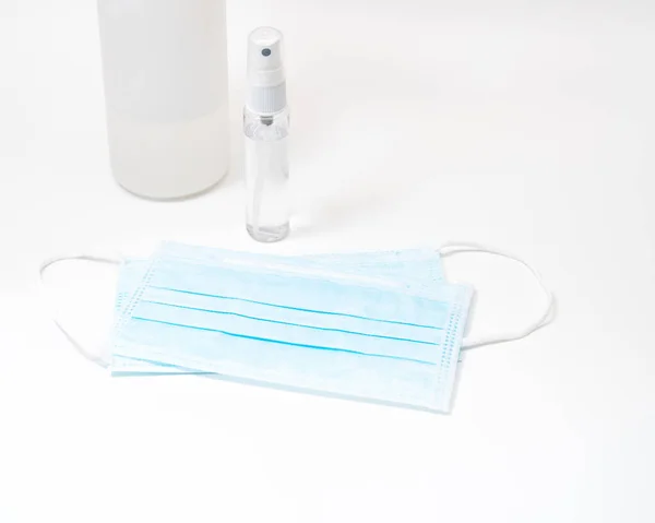 Protective face mask and sanitizer gel dispenser on white background, against Novel coronavirus (2019-nCoV) or Wuhan coronavirus and Influenza. Antiseptic, Hygiene and Healthcare concept