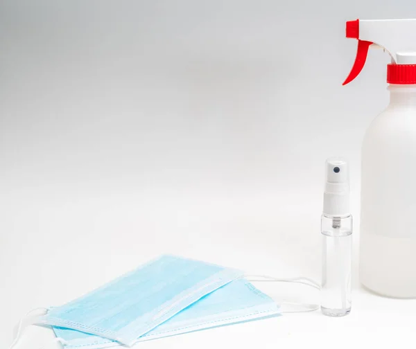 Protective face mask and sanitizer gel dispenser on white background, against Novel coronavirus (2019-nCoV) or Wuhan coronavirus and Influenza. Antiseptic, Hygiene and Healthcare concept