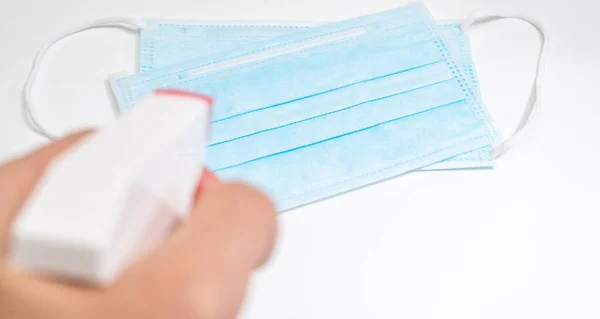 Protective face mask and sanitizer gel dispenser on white background, against Novel coronavirus (2019-nCoV) or Wuhan coronavirus and Influenza. Antiseptic, Hygiene and Healthcare concept