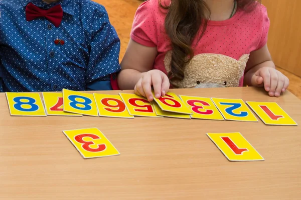 Math lesson in elementary school. Kids are playing. Educational games. A child in kindergarten. Hands of a child. Math tablets