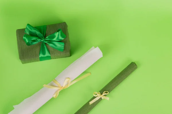 wrapped gift wrapping paper. green paper in a roll. Gift in green packaging. White paper in a roll