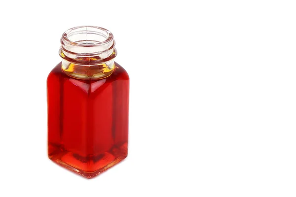 Butelka z rose hip oil na białym tle — Zdjęcie stockowe