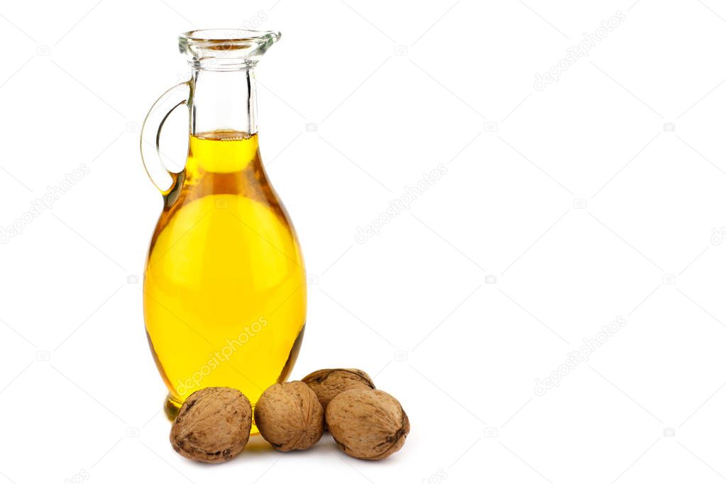 Walnut oil and nuts isolated on white background