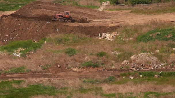 Bulldozer está nivelando montículo de tierra — Vídeos de Stock