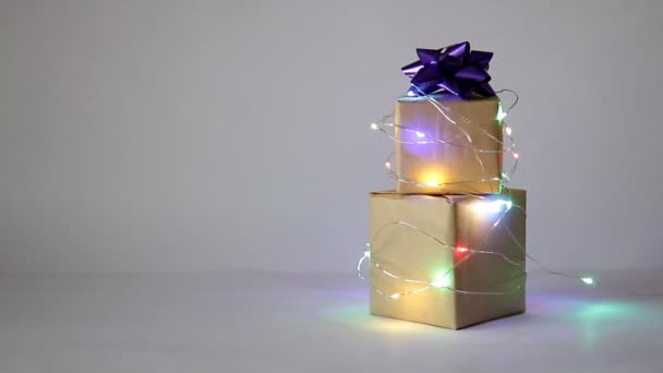 Gifts Craft Paper Boxes Wrapped Blinking Lighting Garland Light Background — Stock Video